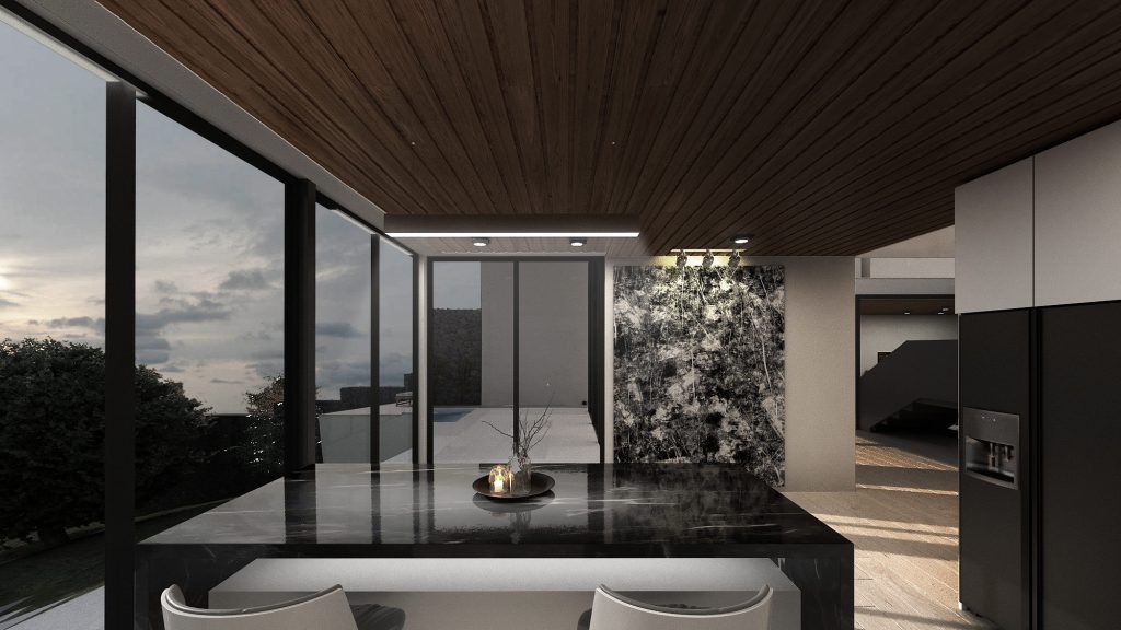 A kitchen with a dark stone island and a backlit marble wall beside tall windows onto the landscape.