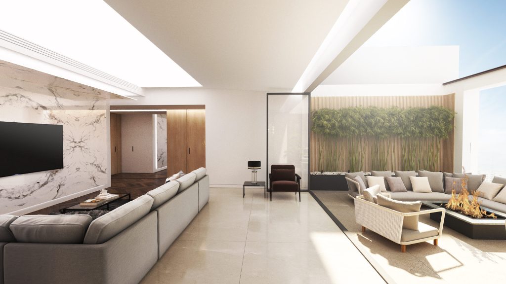 A living room with a gray sofa, a marble TV wall and glass doors onto a terrace with a bamboo wall.