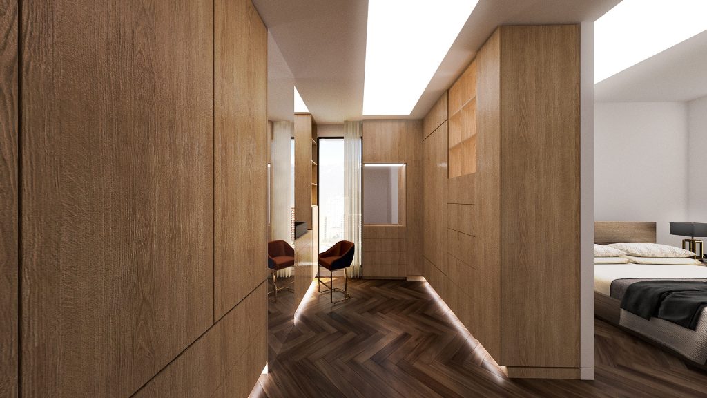 A corridor lined with warm wood panels and a herringbone floor, leading to a bedroom.