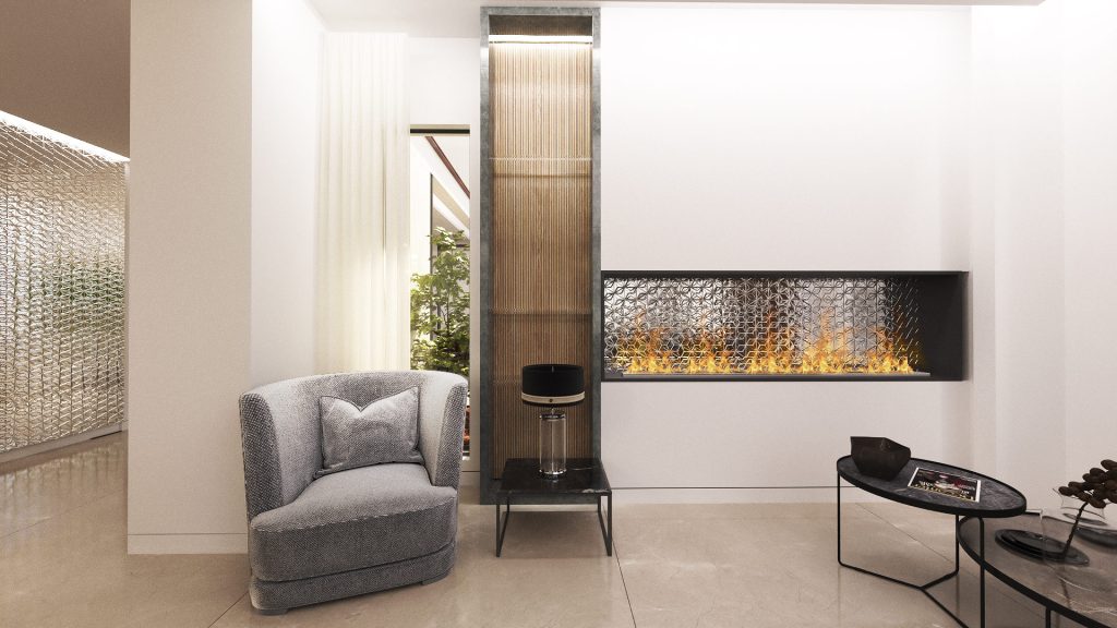 A gray armchair beside a long linear fireplace set into a white wall with a wood column.