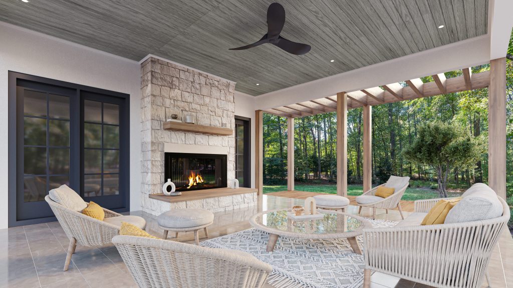 The porch with the stone fireplace and a light gray ceiling, white wicker seating and a view through the pergola to the wooded yard.