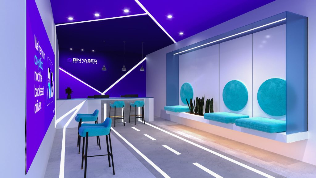The lounge with road markings on the floor, a glass display wall with round teal graphics, teal bar stools at a counter and purple walls.