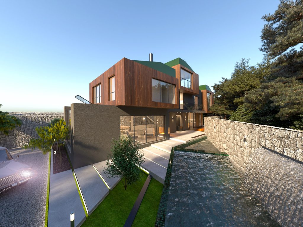The villa at dusk on its forest slope, with lit windows, timber cladding, a green roof edge and a stone-walled garden path.