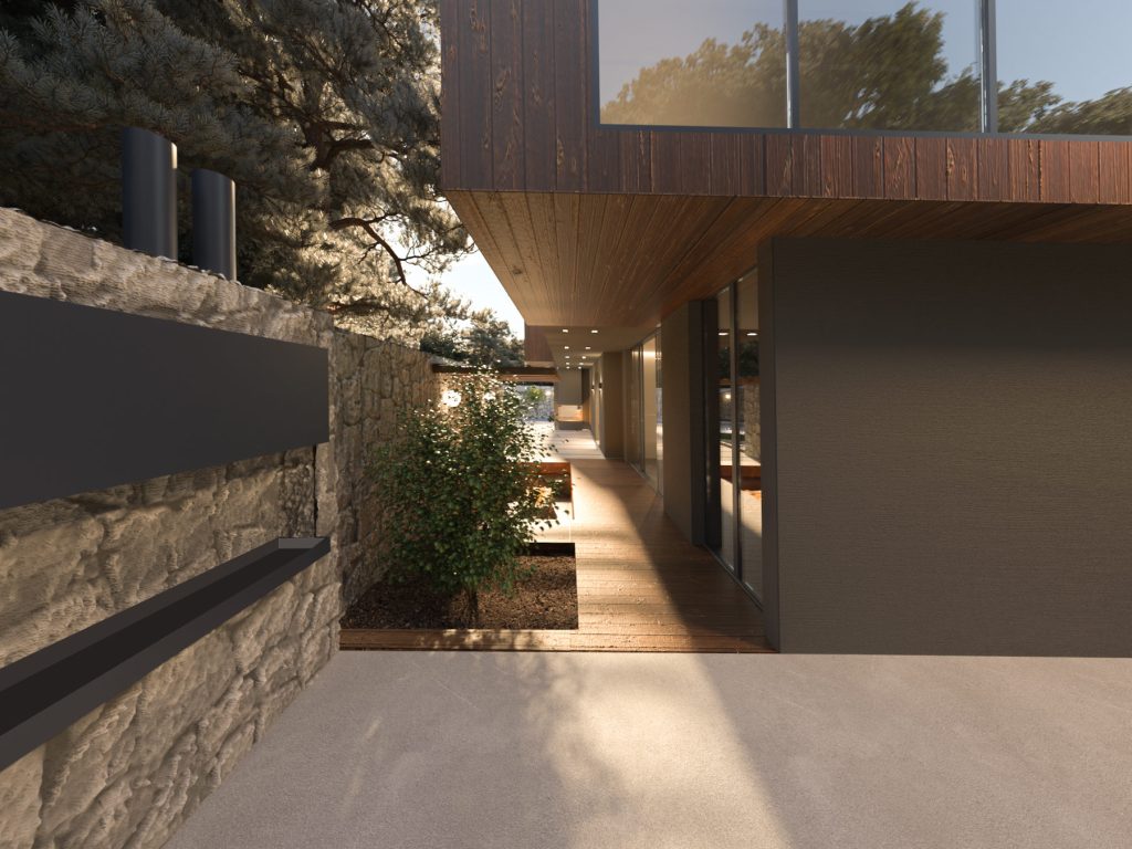 A covered terrace beside a dry-stone wall, with a timber soffit, warm wall lights and planting.