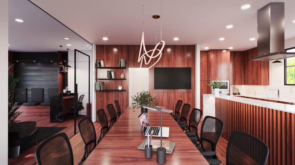 A long conference table with black chairs in the former living room, under a sculptural pendant, with red wood walls and a kitchen corner.