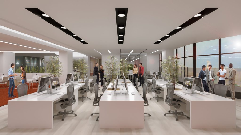 An open office with long white workstations, people meeting between the desks and tall windows over the city.