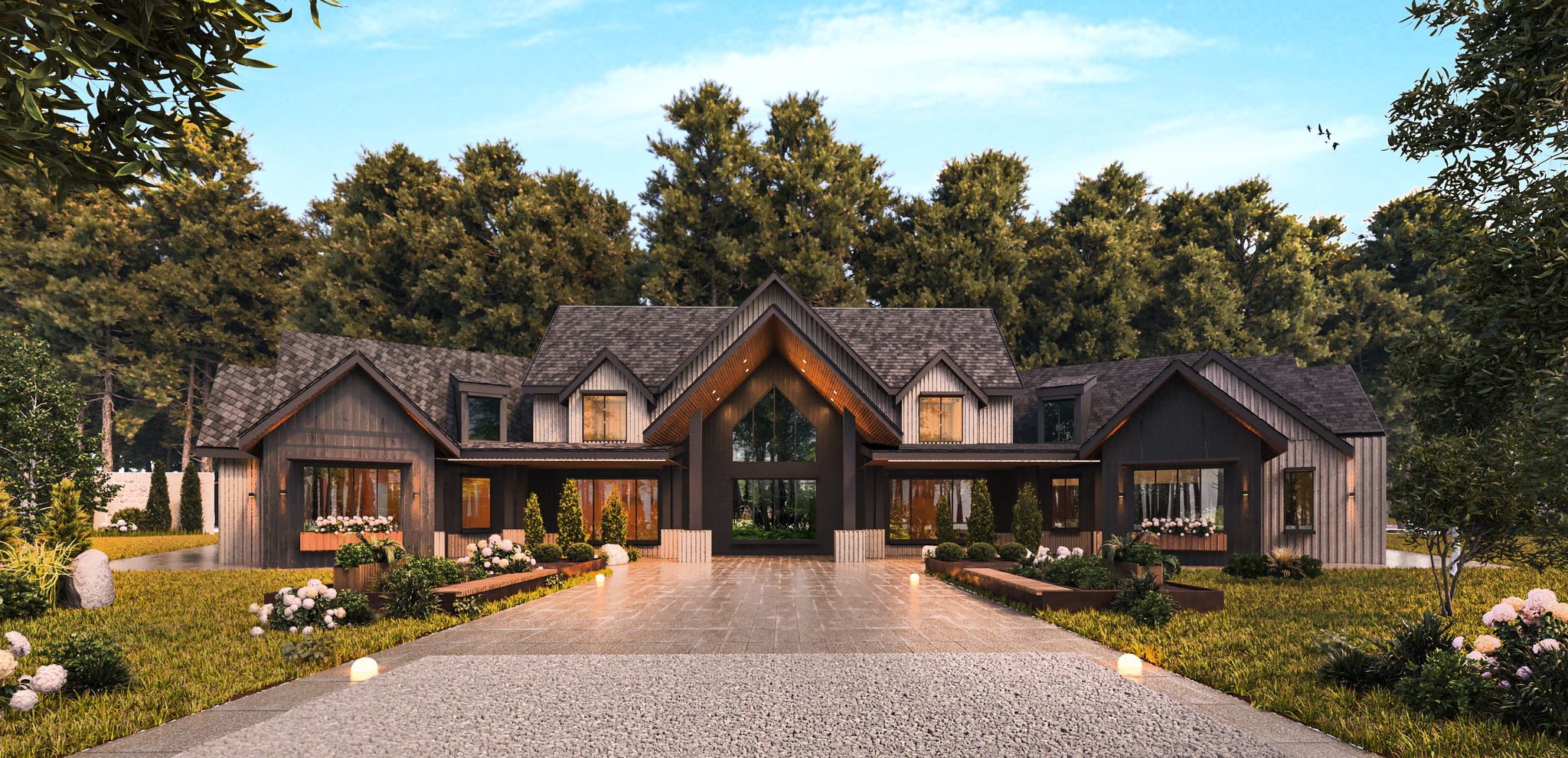 A large lodge-style house with dark cladding, tall glass gables and a long paved drive through a lawn with mature trees.