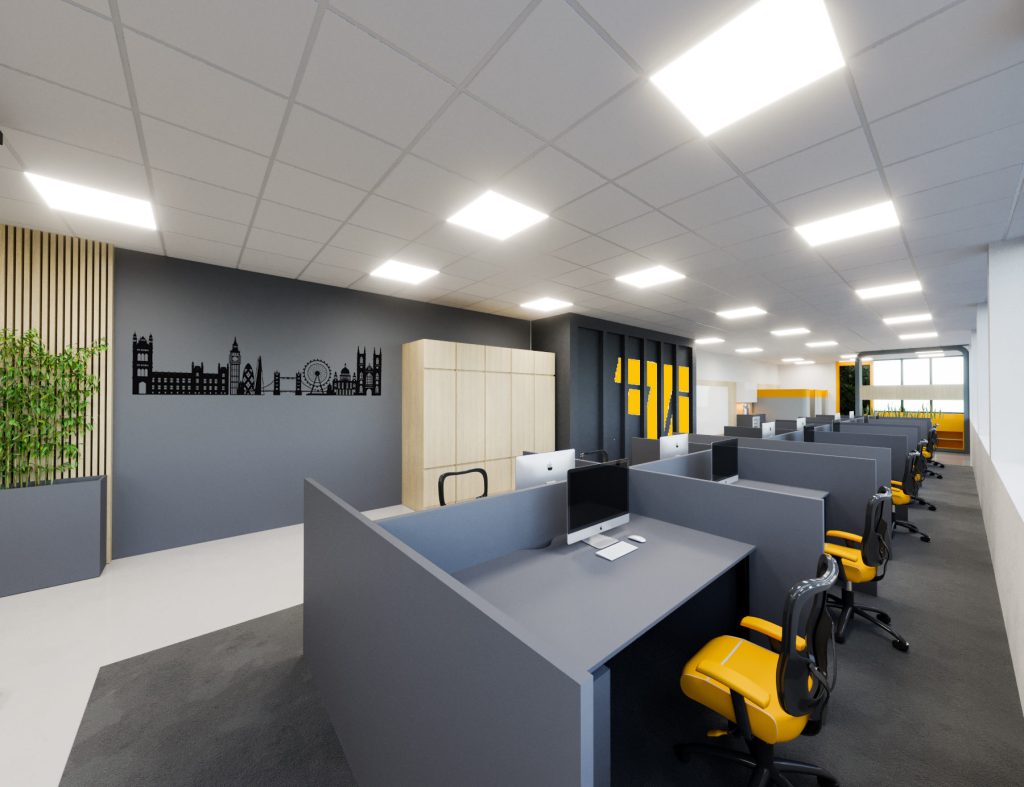 Rows of gray workstations with yellow chairs on a dark carpet path, a city skyline graphic on a gray wall and lockers with yellow doors.