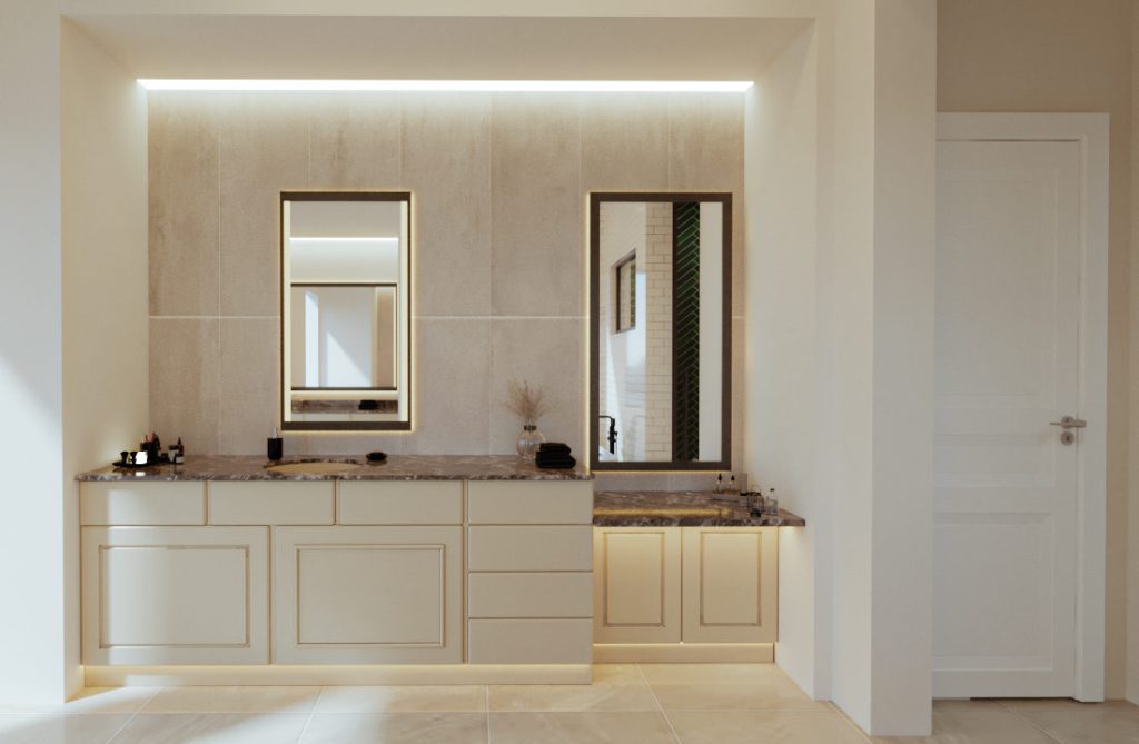A separate vanity area with cream cabinets, a dark stone counter, framed mirrors and a warm backlit niche.