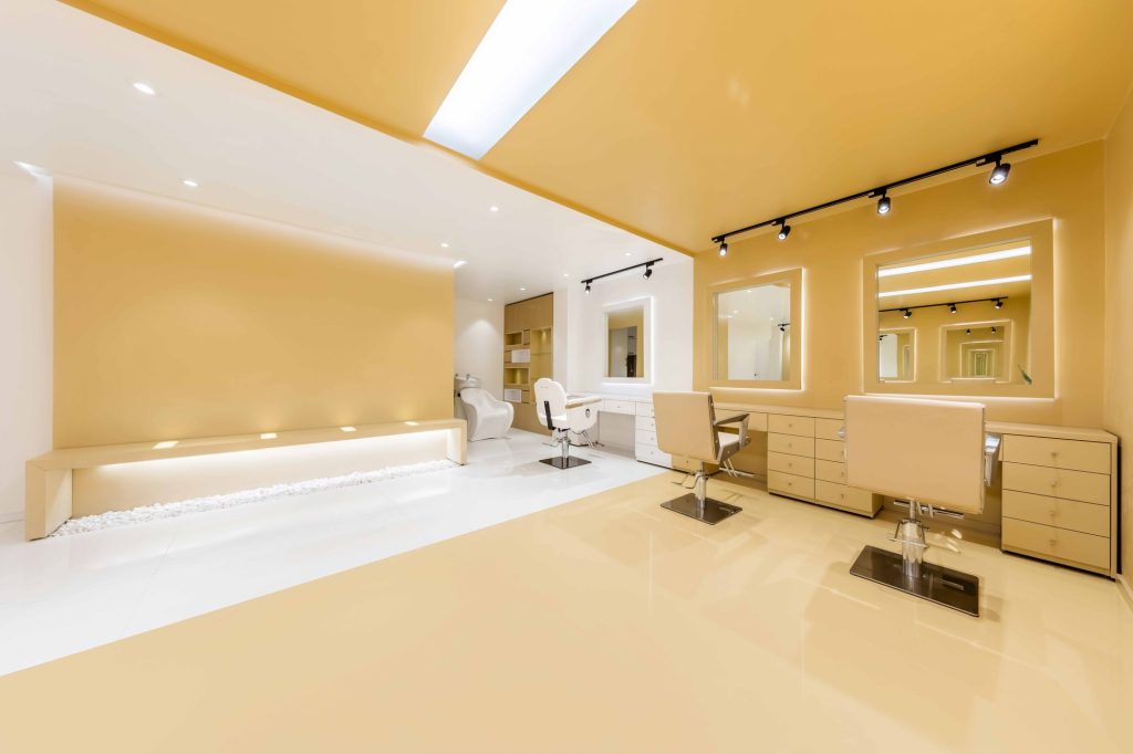 Styling stations with backlit mirrors and a long low bench with hidden light.