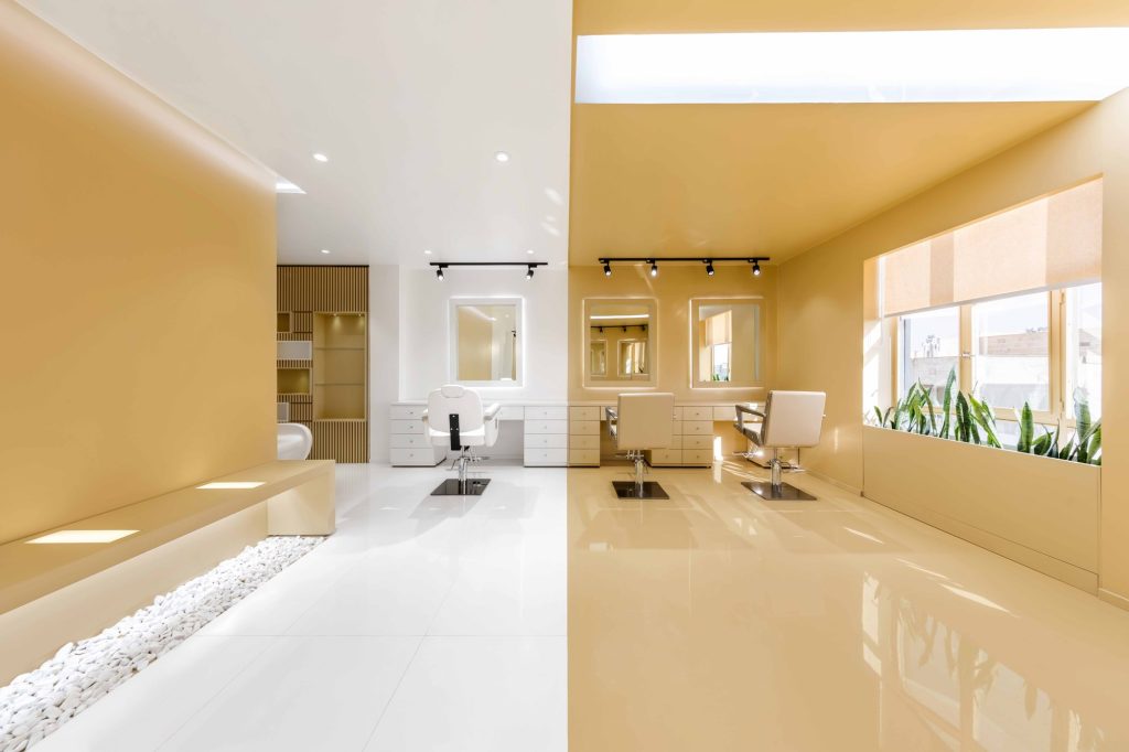 Golden and white planes meeting across the salon, with plants along the window.