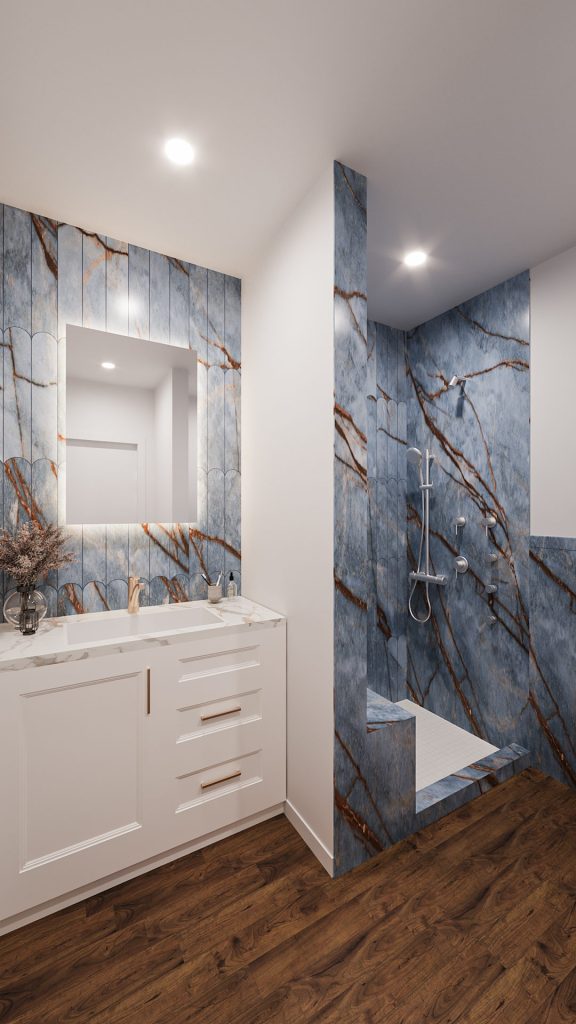 A white vanity with a lit mirror beside the blue marble shower in a compact bathroom.