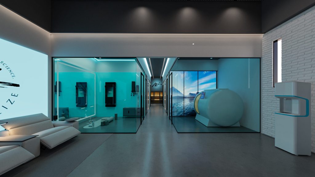 A view down a row of teal glass treatment rooms with a chamber pod and equipment inside, a glossy floor and a white brick wall.