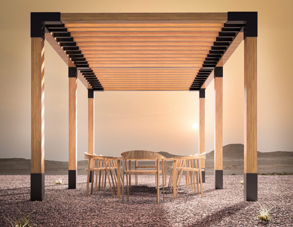 The wooden pergola at sunset, with black steel brackets at the corners and a dining table and chairs underneath.