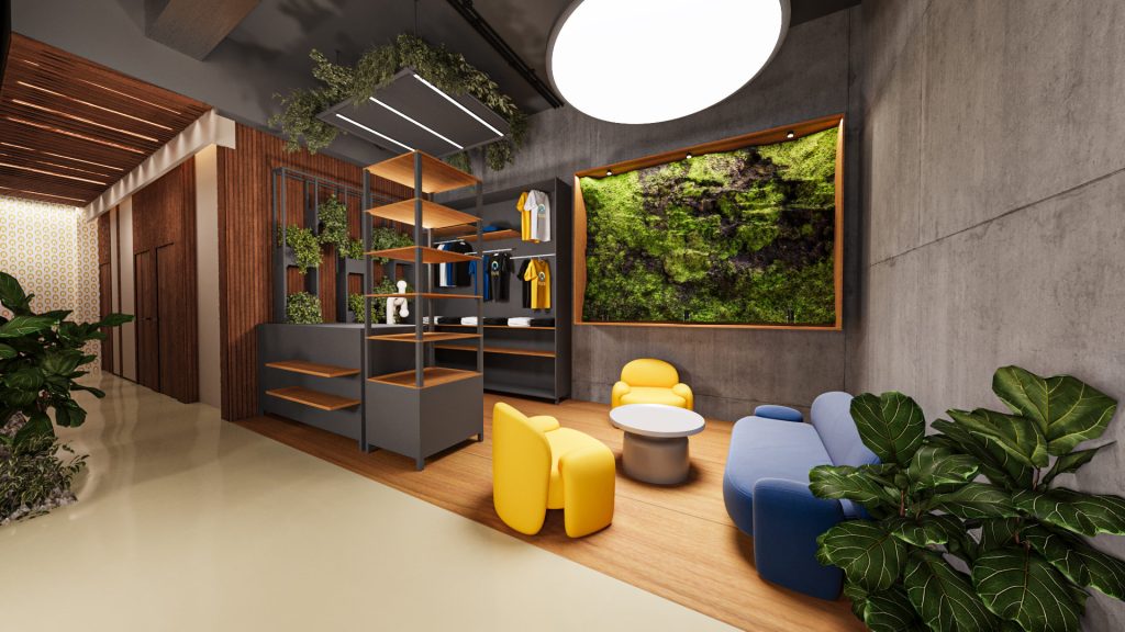 A lounge with yellow and blue armchairs, open shelving, wood slats, a moss wall panel and a round pendant under an open concrete ceiling.